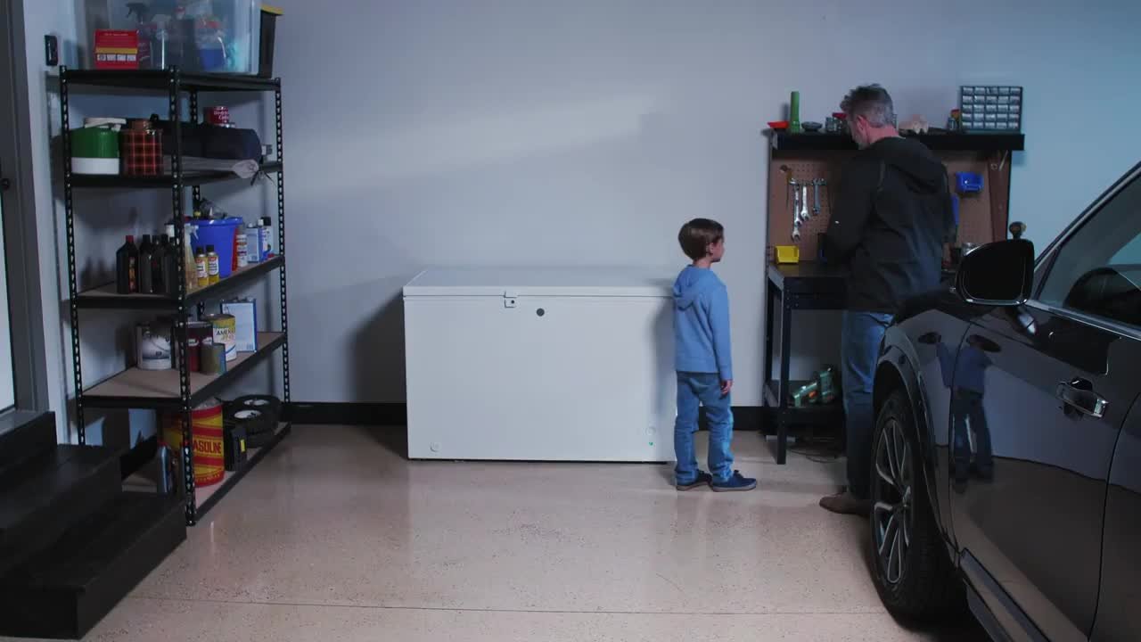 A chest freezer positioned with clear space around it in a warm garage, with items stored away from the freezer to allow airflow
