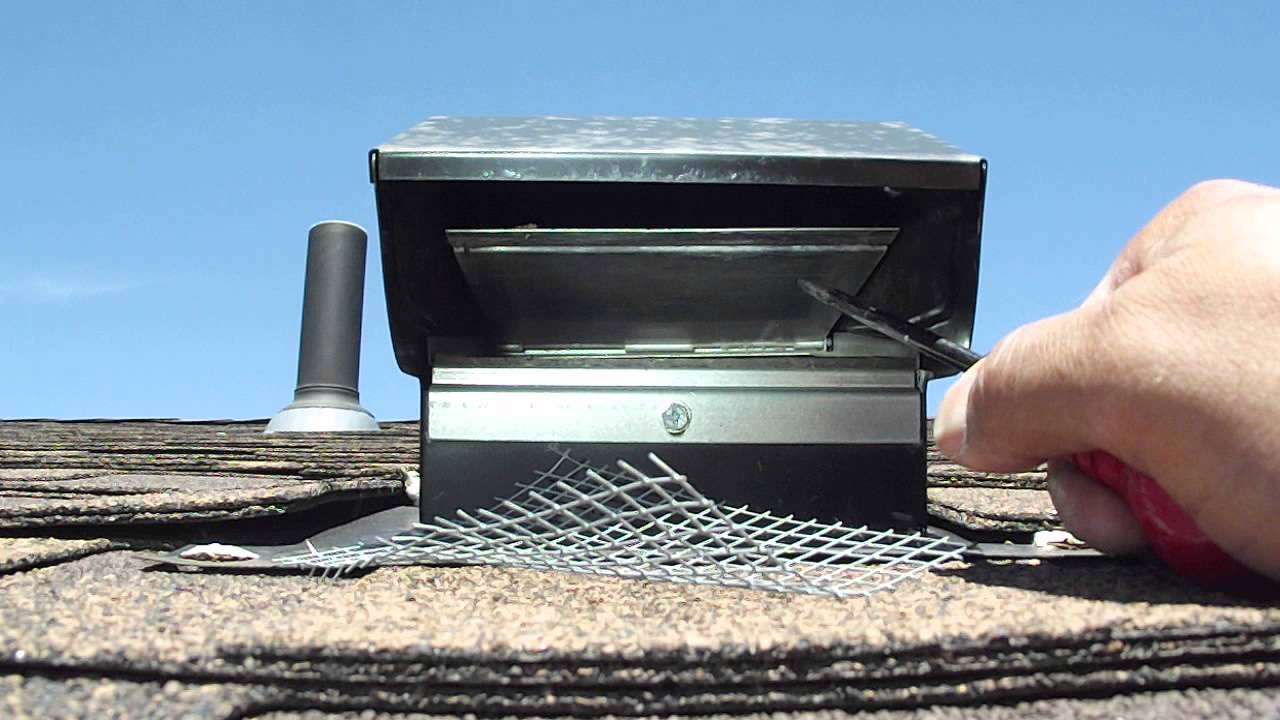 A close-up photo of a bathroom exhaust vent hood on an exterior wall with the flap stuck closed and lint buildup visible around the opening