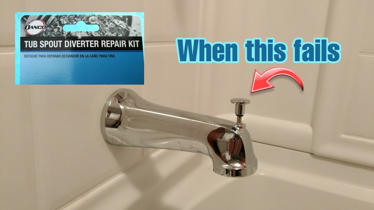 A close-up photo of a chrome tub spout with a pull-up diverter knob, with a homeowner's hand holding adjustable pliers wrapped in a cloth near the spout, in a real bathroom