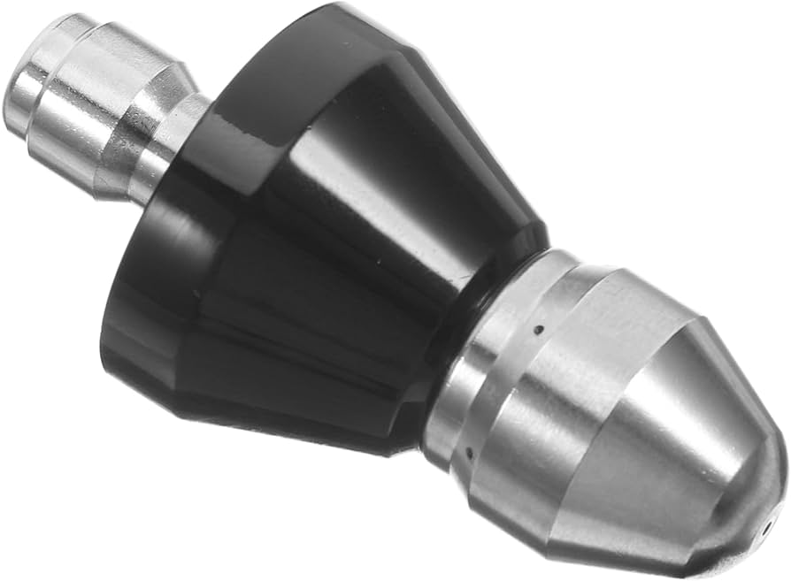 A close up photo of a hand holding a pressure washer spray tip while using a small nozzle cleaning wire tool to clear the orifice, outdoors with natural light