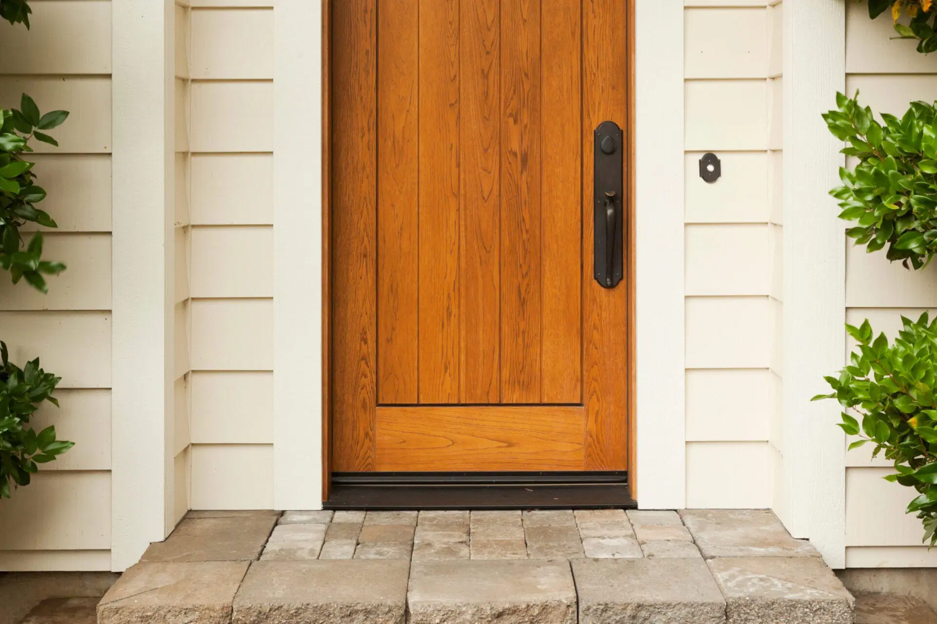 A close view of a door sweep installed along the bottom edge of an exterior door