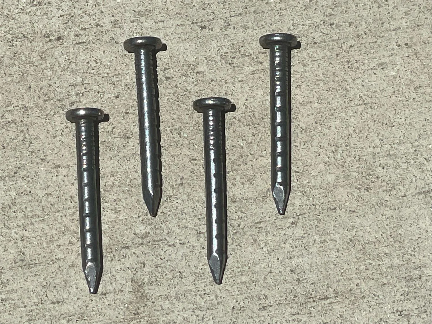 A galvanized joist hanger installed with the correct connector nails in every required hole