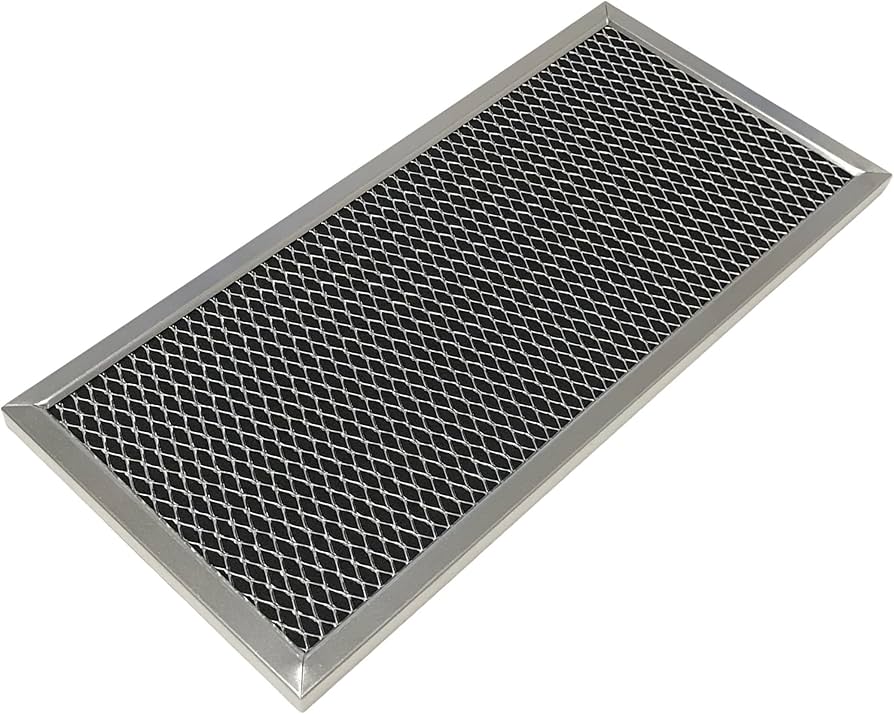 A homeowner removing the top front grille of an over-the-range microwave to access the charcoal filter