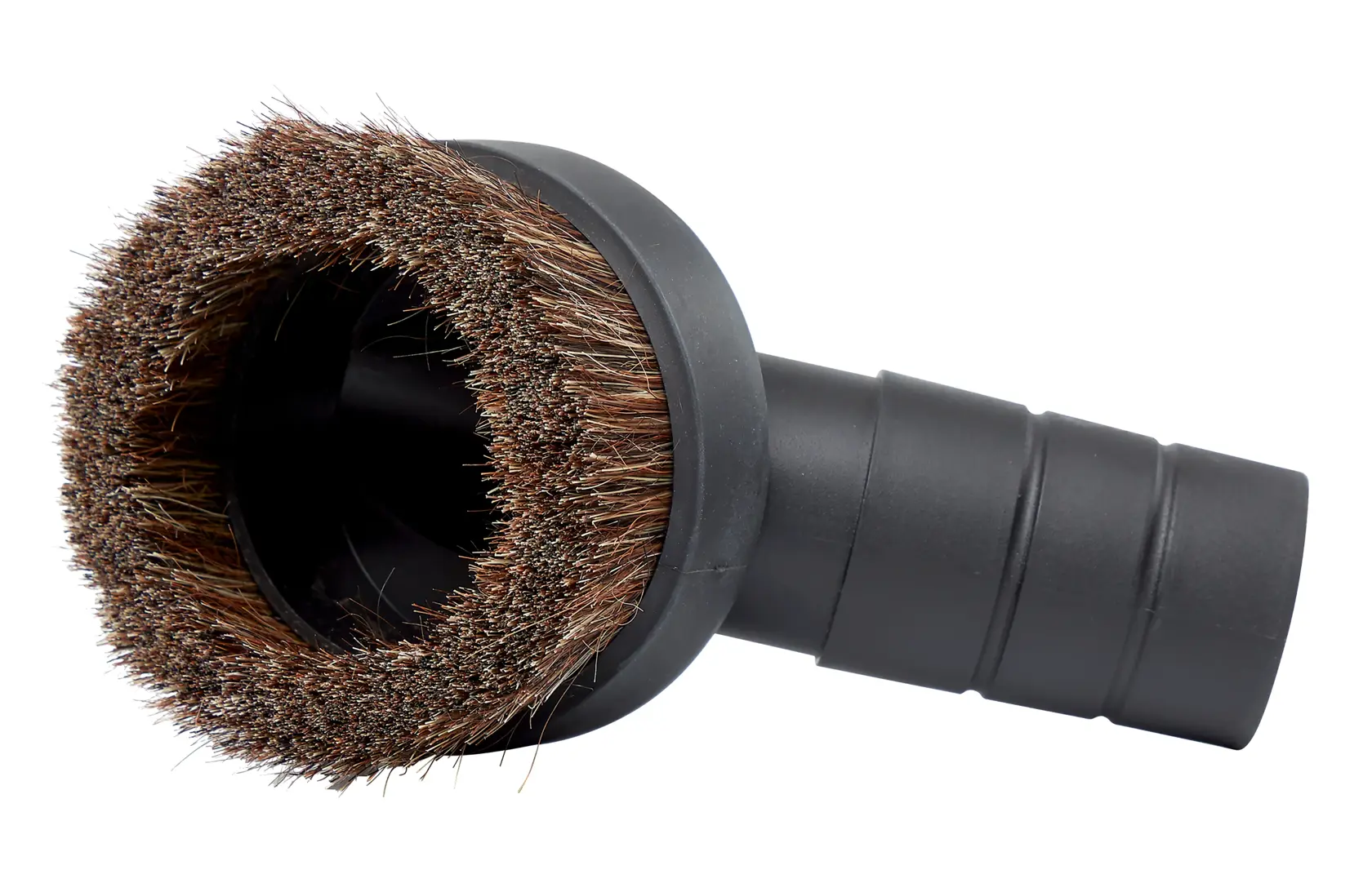 A household vacuum hose with a soft brush attachment positioned at the corner of a windowsill for gentle cleaning