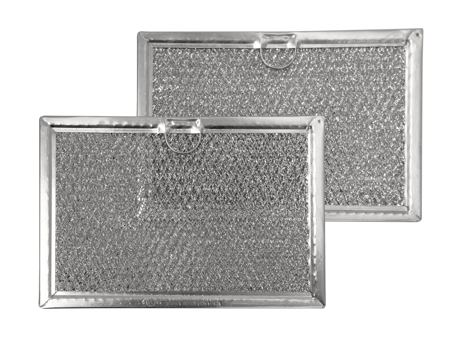 A metal mesh grease filter removed from an over-the-range microwave, held over a kitchen counter