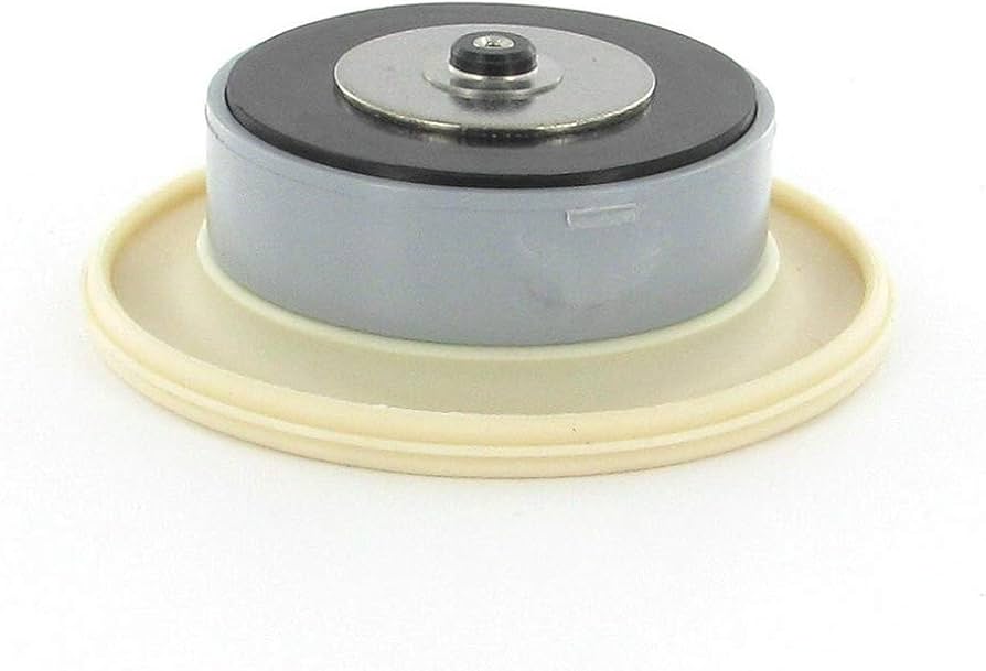 A plastic irrigation valve bonnet removed with a rubber diaphragm and spring laid on a truck tailgate beside basic hand tools, outdoor photo