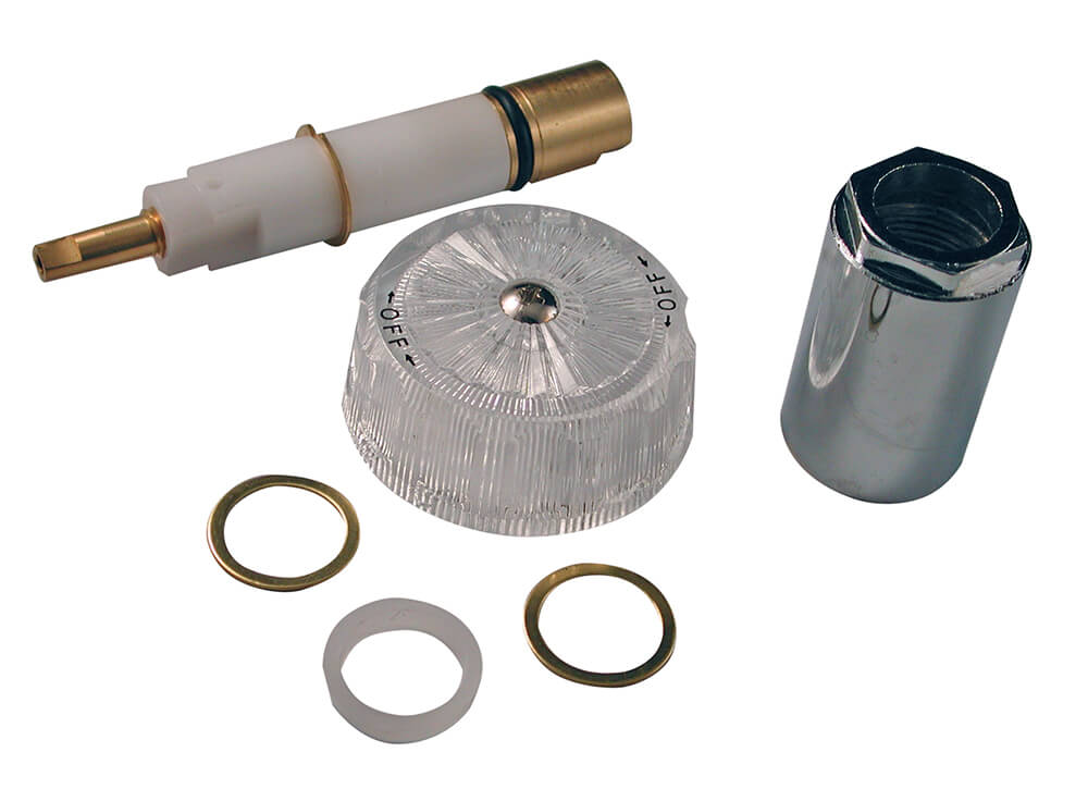 A real bathroom shower valve with the trim plate removed, showing a single-handle mixing valve body and cartridge opening ready for service