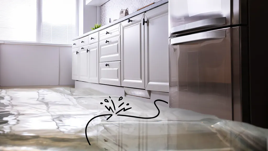 A real-life kitchen scene with a refrigerator door open and a small puddle of water on the floor beneath the ice maker area, natural indoor lighting