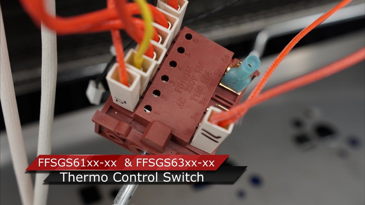 A real photo close-up of a charred spade connector and heat-damaged wire inside an electric stove control cavity