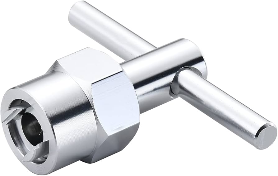 A real photo of a cartridge puller tool attached to a shower valve cartridge, mid-removal with the trim plate off