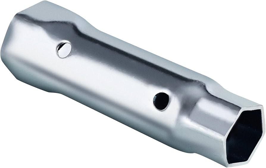 A real photo of a homeowner loosening a water heater anode rod on top of a tank using a long breaker bar and a deep socket in a basement utility room