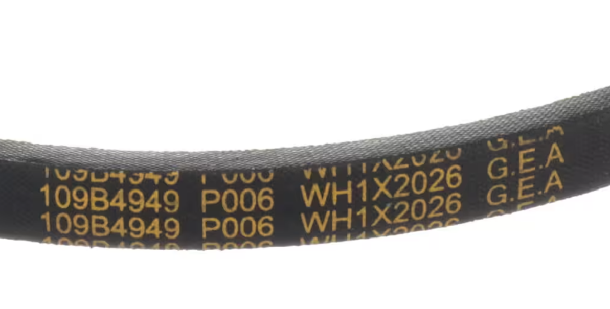 A real photo of a washing machine tilted back with the bottom access panel removed, showing a person inspecting a rubber drive belt on a pulley