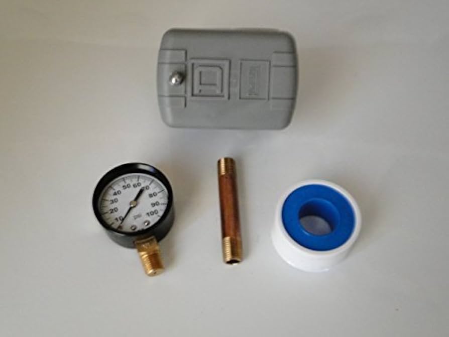 A small threaded metal nipple and fittings under a well pressure switch near a pressure tank, showing rust and mineral buildup