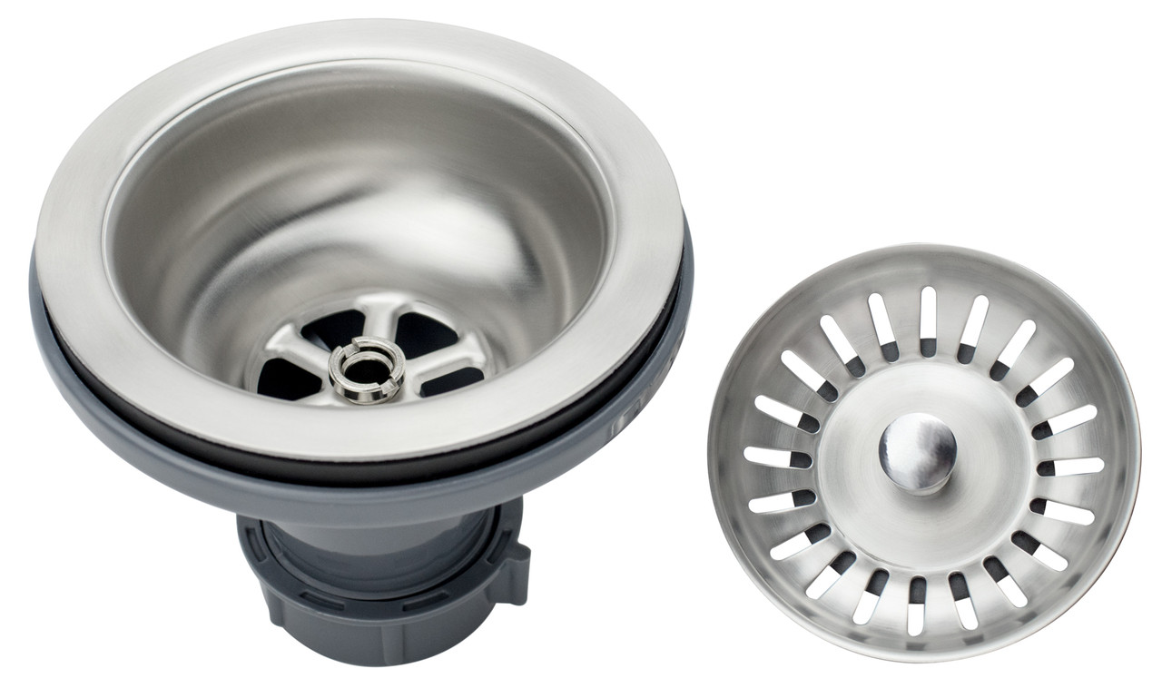 A stainless steel sink strainer sitting in a kitchen sink drain opening with a few vegetable scraps caught inside