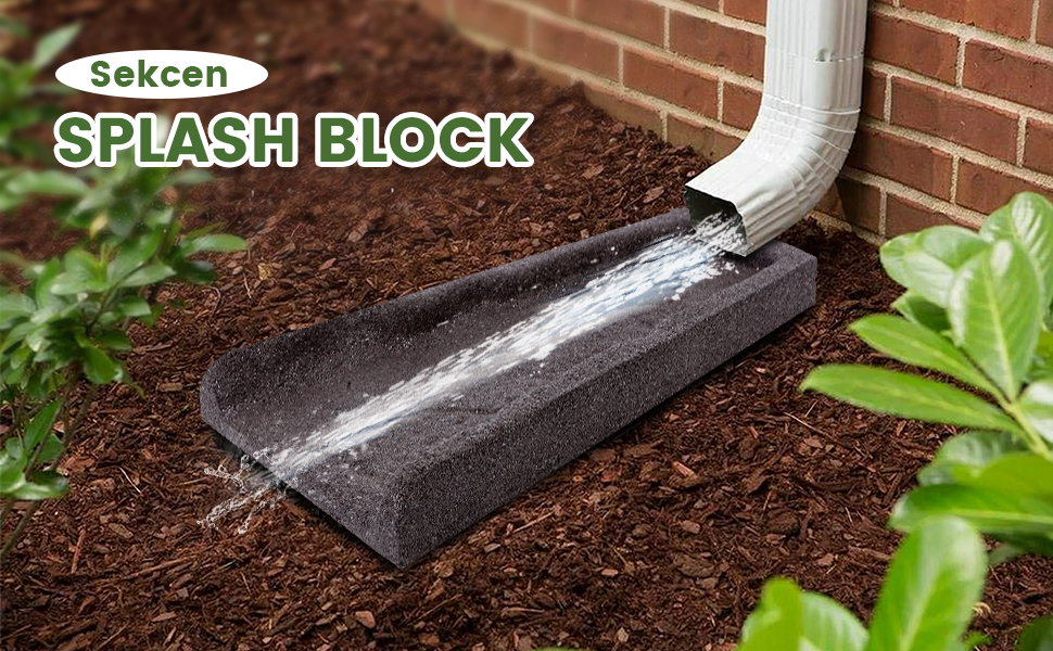 A white vinyl downspout connected to a flexible extension draining onto a concrete splash block that directs water away from a home's foundation