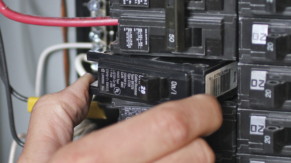 An open residential electrical panel showing a double-pole breaker labeled for a well pump circuit, photographed straight on