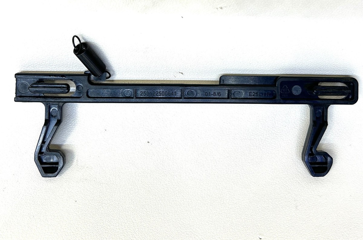 Close-up of a microwave door latch area showing the plastic latch hooks and the receiving slots on the microwave frame